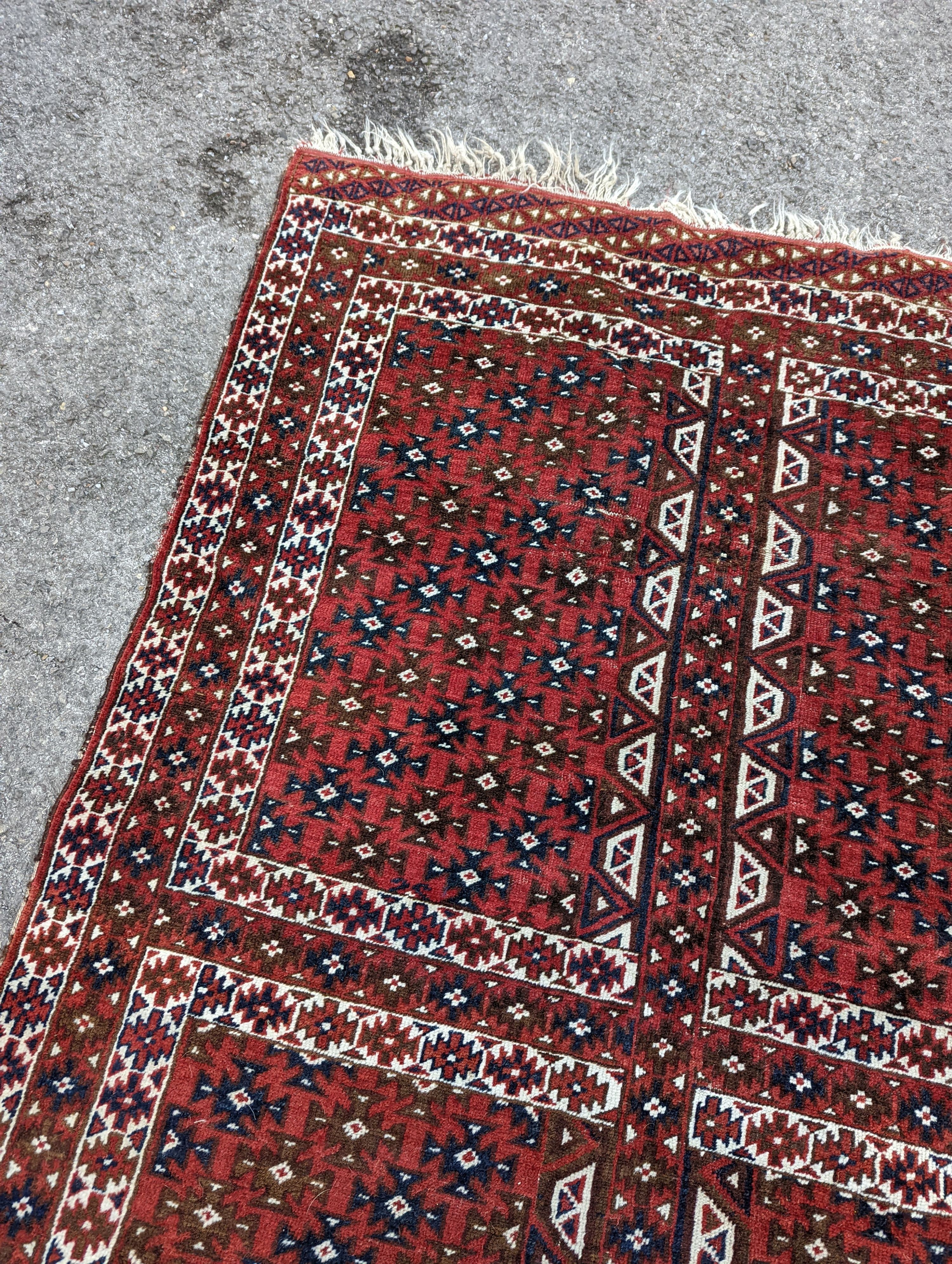 A Belouch red ground rug, 200 x 130cm